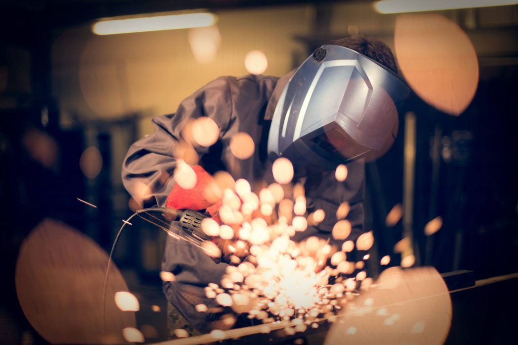 Employee-grinding-steel-with-sparks